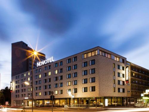 a hotel building with a sign on top of it at Novotel Hamburg City Alster in Hamburg