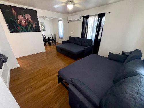 a living room with a blue couch at Flowers Apt 5 Min Walk to Downtown - Free Parking in Las Vegas