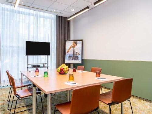 a conference room with a large table and chairs at Novotel Hamburg City Alster in Hamburg