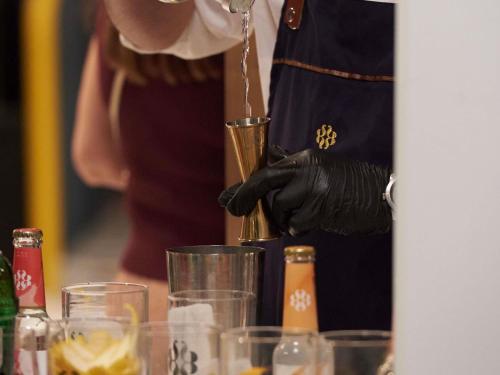 a person is pours a drink into a cup at Ibis Madrid Aeropuerto Barajas in Madrid