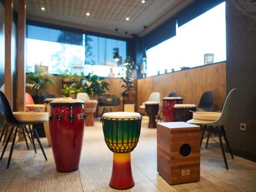 a room with many different colored vases on the floor at Ibis Madrid Aeropuerto Barajas in Madrid