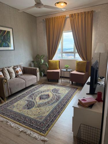 a living room with a couch and a rug at At Sky Palace Kuala Terengganu in Kuala Terengganu