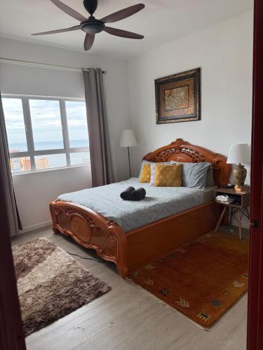 a bedroom with a large bed with a ceiling fan at At Sky Palace Kuala Terengganu in Kuala Terengganu