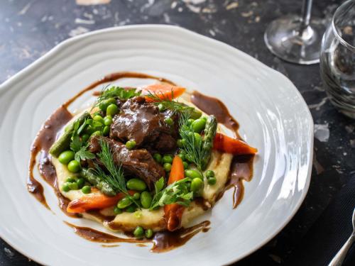 a plate of food with meat and vegetables on a table at Novotel Paris 17 in Paris