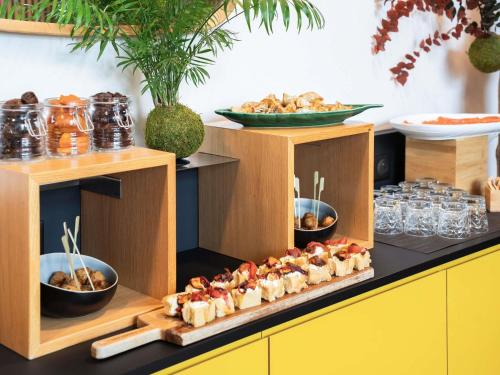a buffet with some food on top at Novotel Paris 17 in Paris