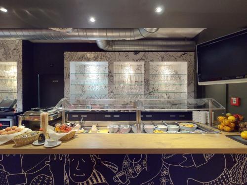 a kitchen with a counter with food on it at ibis Hotel Köln Airport in Cologne