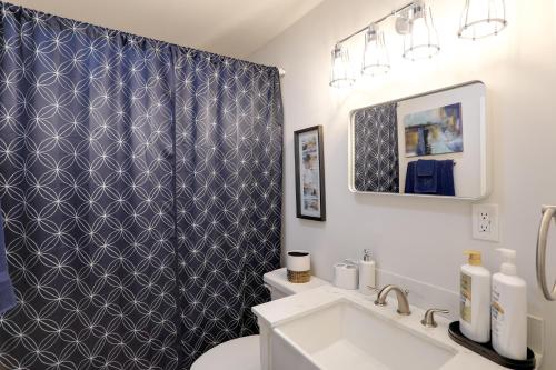 a bathroom with a toilet and a shower curtain at Updated North Greenwood Cottage Less Than 1 Mi to Dtwn! in Greenwood