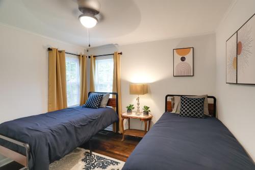 a bedroom with two beds and a window at Updated North Greenwood Cottage Less Than 1 Mi to Dtwn! in Greenwood