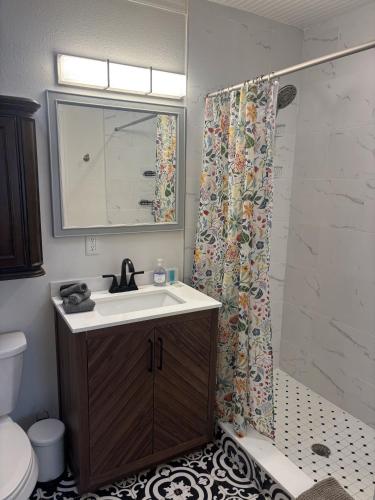 a bathroom with a sink and a shower curtain at Seaside Retreat Cottages #3 in Clearwater Beach