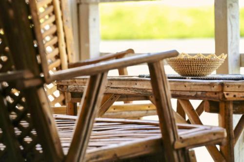 a wooden table with a bowl on top of it at Maison flottante SWEET MALBALY - chambre double - vue imprenable sur mer- iles du saloum in Fatick