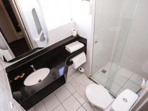 a bathroom with a toilet and a sink and a shower at Ibis Teresina in Teresina
