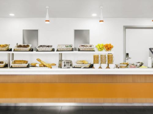 a counter with many different types of food at ibis budget Brugge Centrum Station in Bruges