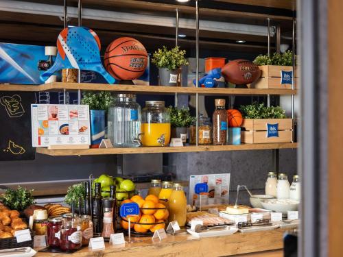 a shelf filled with food and fruits and vegetables at Ibis Budget Madrid Calle Alcalá in Madrid