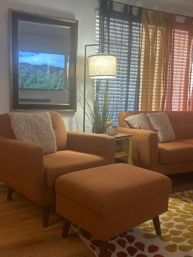 a living room with two couches and a flat screen tv at Entire Vacation home blocks to the Strip, ARTS Dist, & Main Street Sleeps up to 8 in Las Vegas