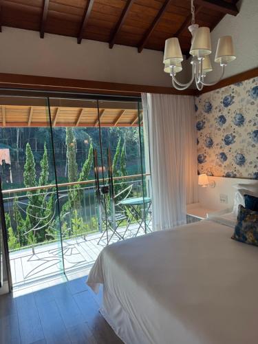 Ένα ή περισσότερα κρεβάτια σε δωμάτιο στο Vale dos Pássaros - Pousada e SPA Suíte 4 Luxo