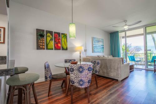 a living room with a table and chairs and a couch at Menehune Shores 601 condo in Kihei