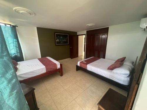 a room with two beds in a hotel room at Estrella de Mar in Rodadero