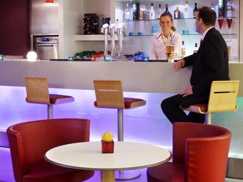 a man and a woman sitting at a bar at ibis Aberdeen Centre – Quayside in Aberdeen