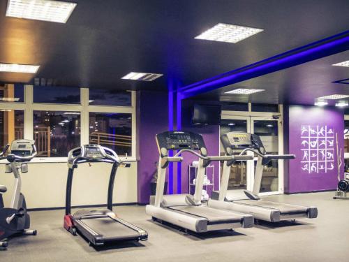 a gym with three exercise bikes in a room at Mercure Sao Jose dos Campos in São José dos Campos