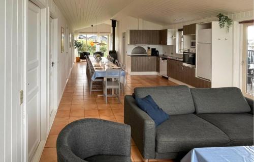 a living room with a couch and a table at Nice Home In Løkken With Kitchen in Løkken