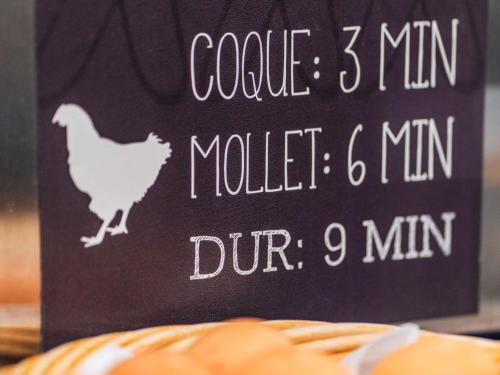 a sign with a chicken on it next to a pumpkin at ibis Styles Toulouse Lavaur in Lavaur