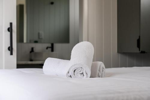a pile of towels sitting on top of a bed at Swell At Cape Bridgewater in Cape Bridgewater