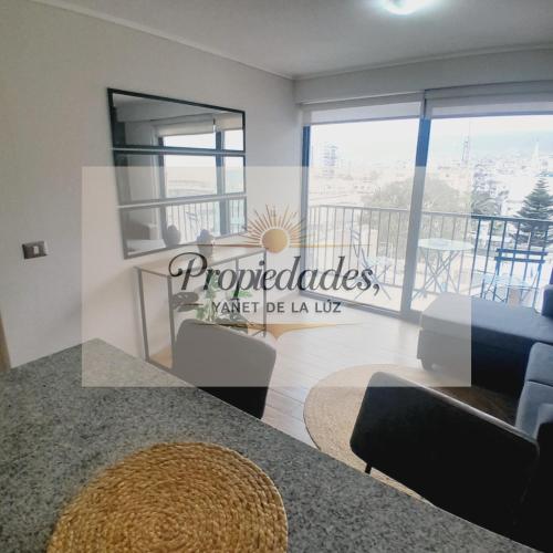 a living room with a view of a balcony at Departamento Central Vip in Antofagasta