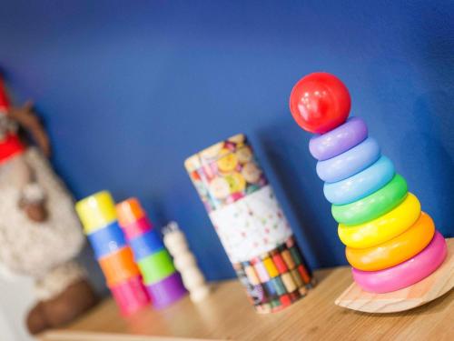 a stack of colorful stacking toys on a table at ibis Styles Toulouse Lavaur in Lavaur