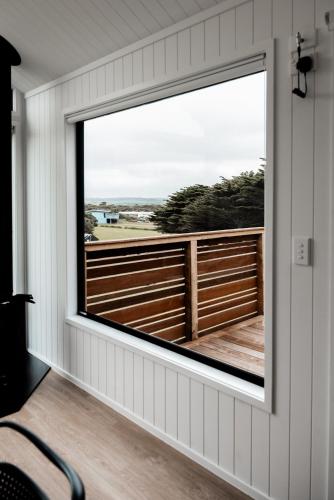 a window in a house with a view of a fence at Swell At Cape Bridgewater in Cape Bridgewater