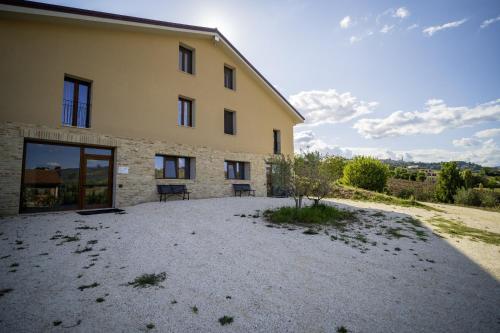 a building with a bench in front of it at La Vigna 1803 in Casa Gagliano