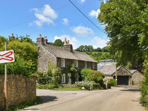 a no left turn sign in front of houses at Hollyhocks Cottage in Helland