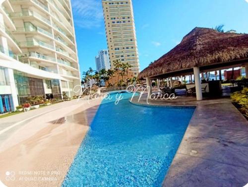 a swimming pool in the middle of a building at Departamento a pie de playa en Camino al Mar in Mazatlán