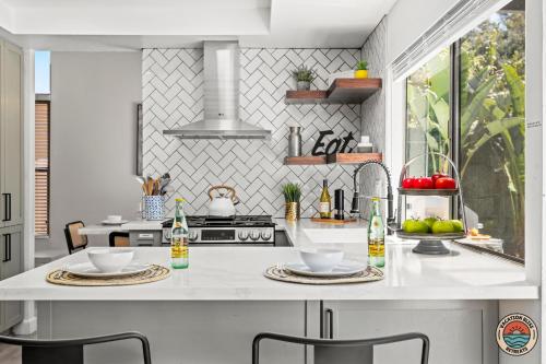 a kitchen with a white counter with two dishes on it at 4BR Chula Vista Getaway Splash, Play & Game! in Chula Vista