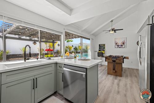 a kitchen with a sink and a large window at 4BR Chula Vista Getaway Splash, Play & Game! in Chula Vista