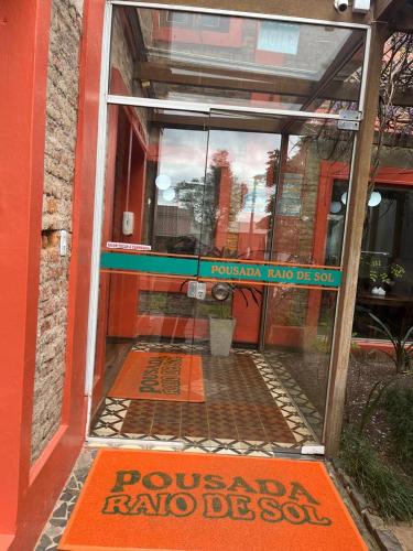 a glass door of a building with a sign on it at Pousada Raio de Sol in Jaguarão