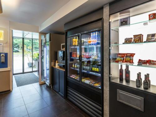 a refrigerator filled with lots of bottles of wine at ibis budget Basel Pratteln in Pratteln