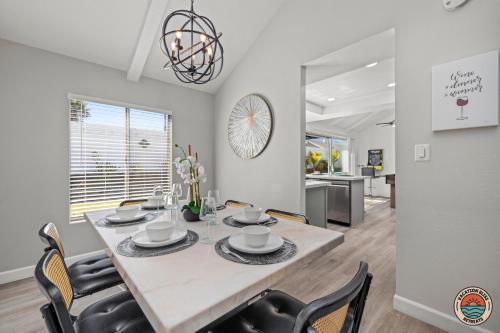 a dining room and kitchen with a table and chairs at 4BR Chula Vista Getaway Splash, Play & Game! in Chula Vista
