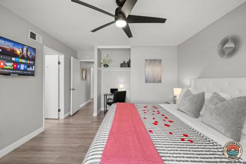 a bedroom with a bed with a ceiling fan at 4BR Chula Vista Getaway Splash, Play & Game! in Chula Vista