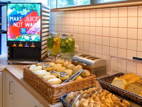 a bakery counter with baskets of bread and pastries at ibis budget Hamburg St Pauli Messe - neu renoviert in Hamburg