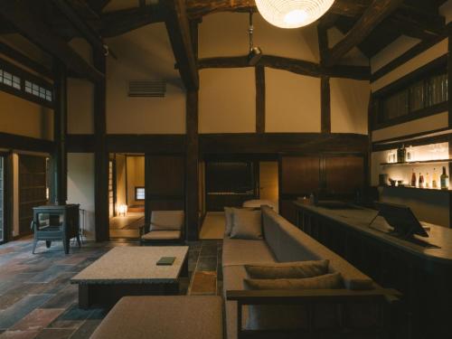 a large living room with a couch and a table at Ujosouan in Kyotango