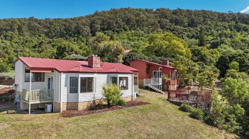 a house with a red roof on top of a yard at Bimbadeen Estate Villa 3 in Mount View
