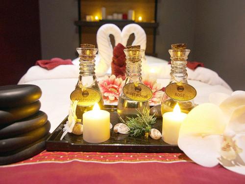 a table with three bottles of wine and candles at Novotel World Trade Centre Dubai in Dubai