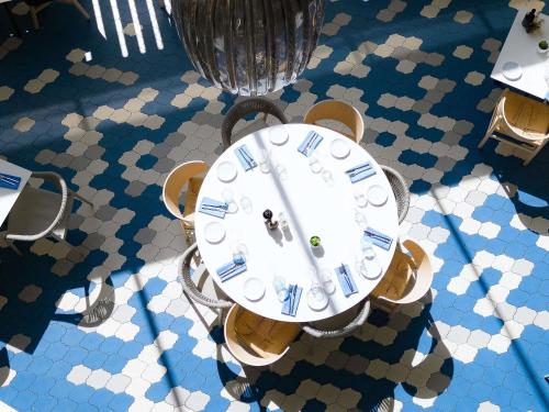 an overhead view of a table with a clock on it at Novotel Monte-Carlo in Monte Carlo