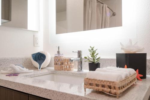 a bathroom counter with a sink and a mirror at Hollywood Stars Walk of Fame Apartment in Los Angeles