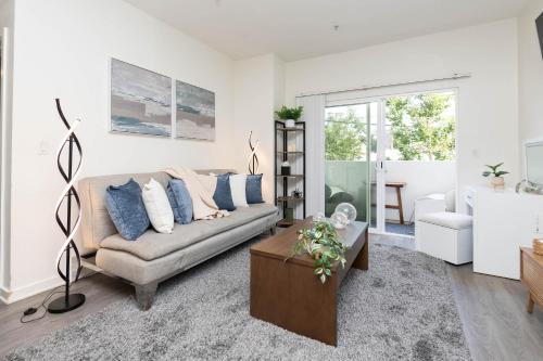 a living room with a couch and a table at Hollywood Stars Walk of Fame Apartment in Los Angeles