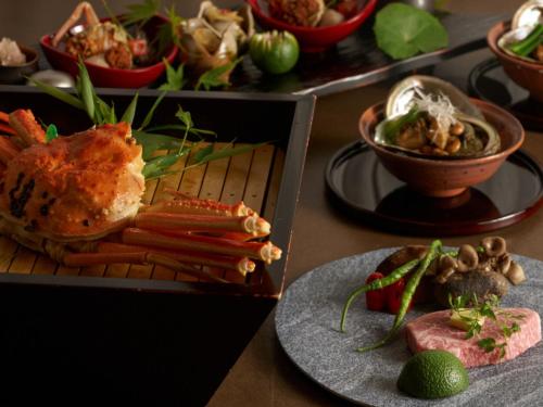 a table with plates of food and bowls of food at Ujosouan in Kyotango