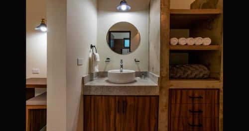 a bathroom with a sink and a mirror at Santa Cruz Suites #1 in La Paz