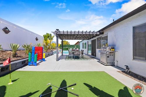 a backyard with a putting green and a golf course at 4BR Chula Vista Getaway Splash, Play & Game! in Chula Vista