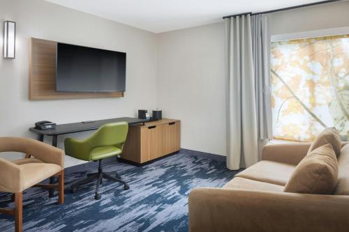 a hotel room with a desk and a tv at Fairfield by Marriott Mission Viejo Orange County in Mission Viejo