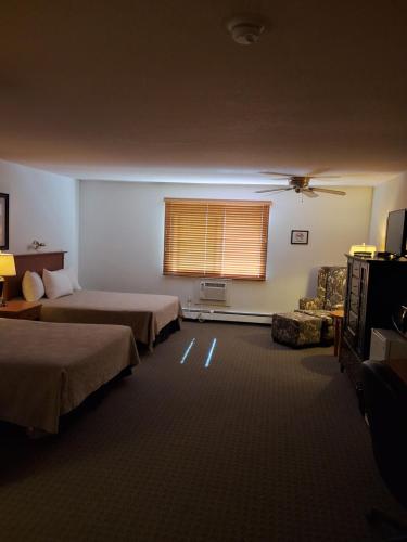 a hotel room with two beds and a window at Wildwood Hotel in Wildwood